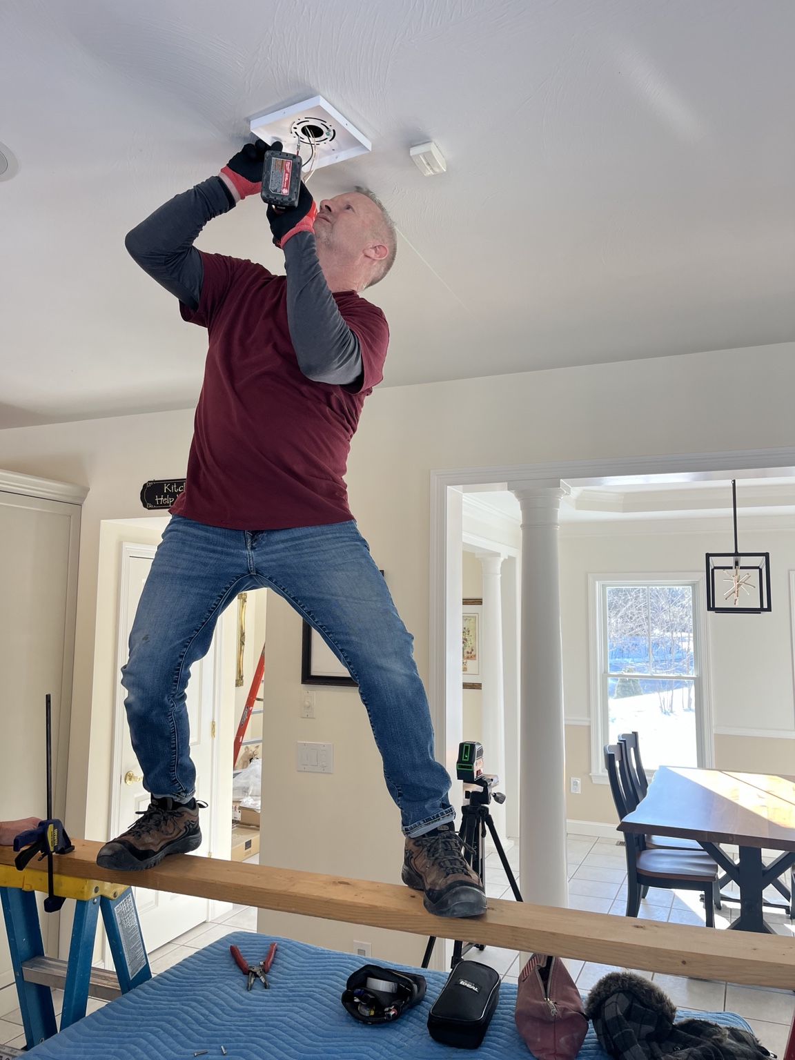 Electrician installing kitchen pendant lighting